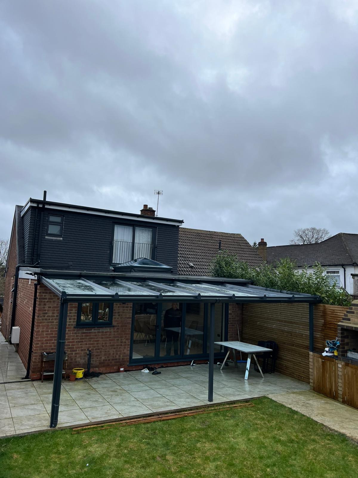 Full view of glass garden room extension with lean-to roof