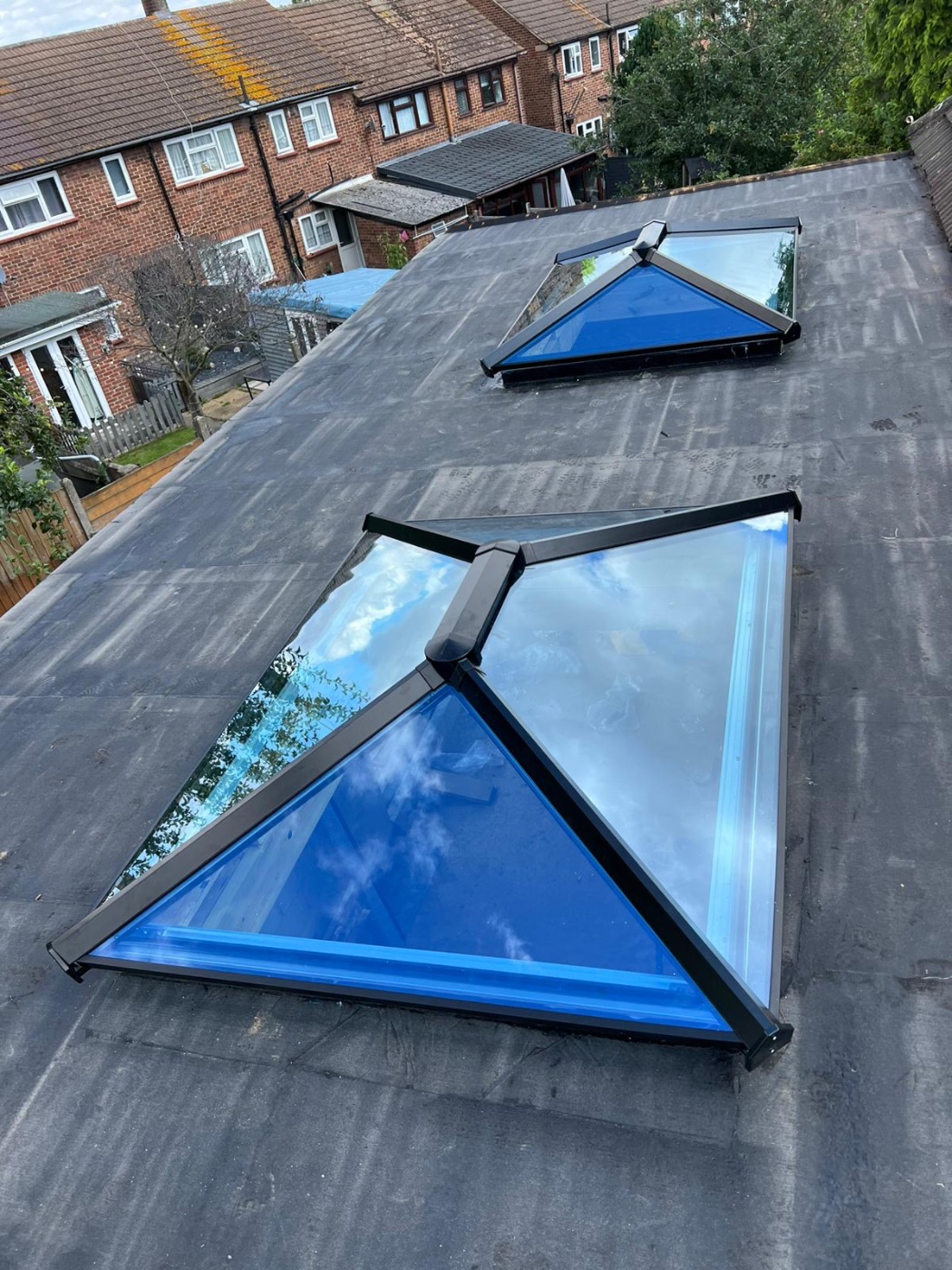 Blue-glass roof lanterns installed on a flat roof